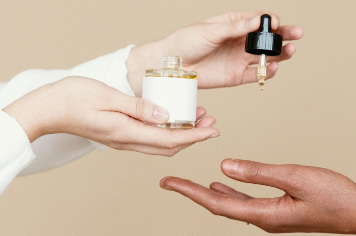 hand holding a dropper bottle.