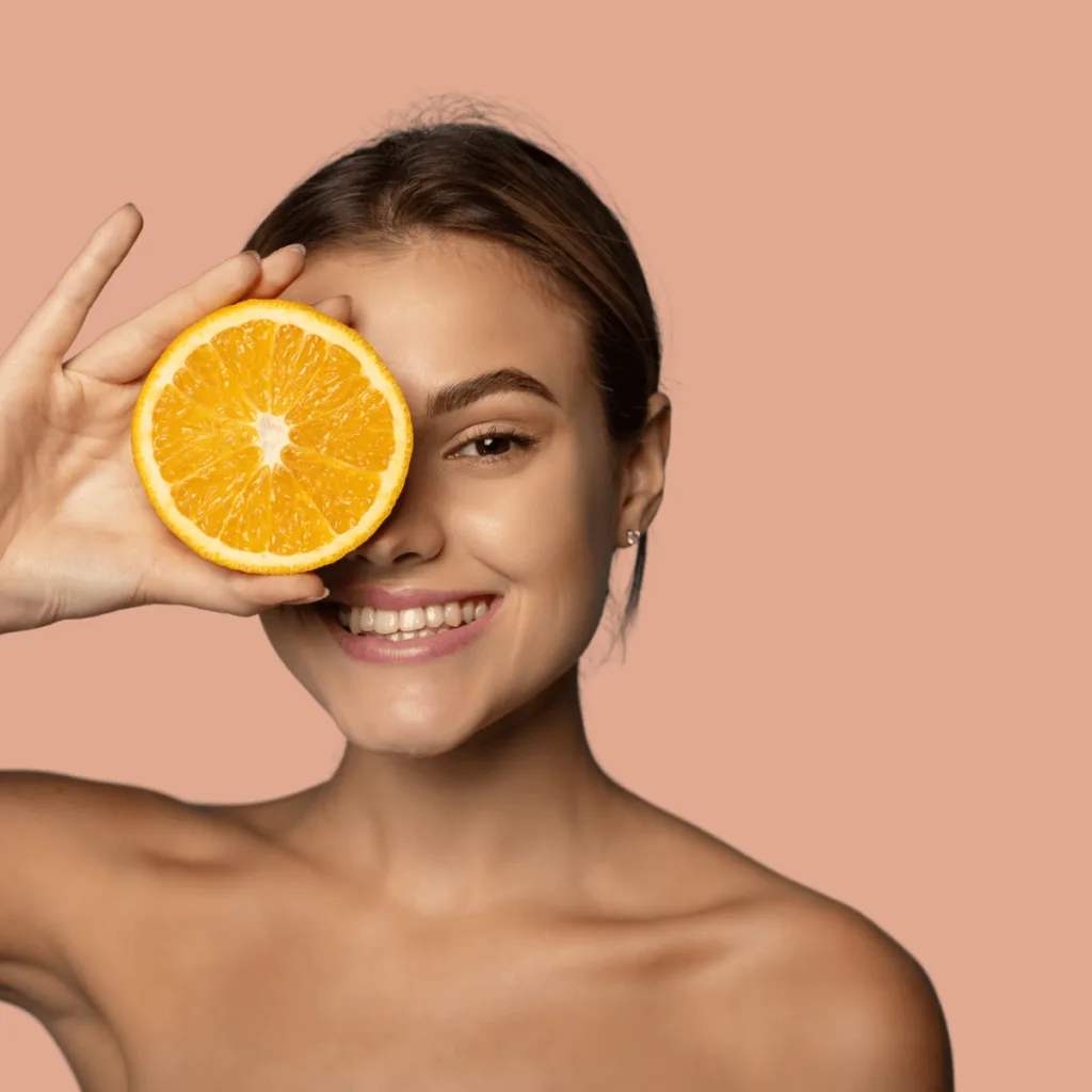 woman using vitamin C rich skincare products 