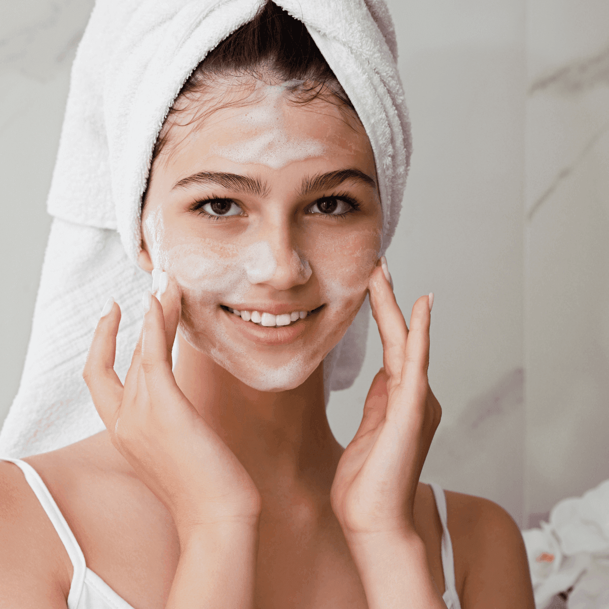 woman cleansing her face at home