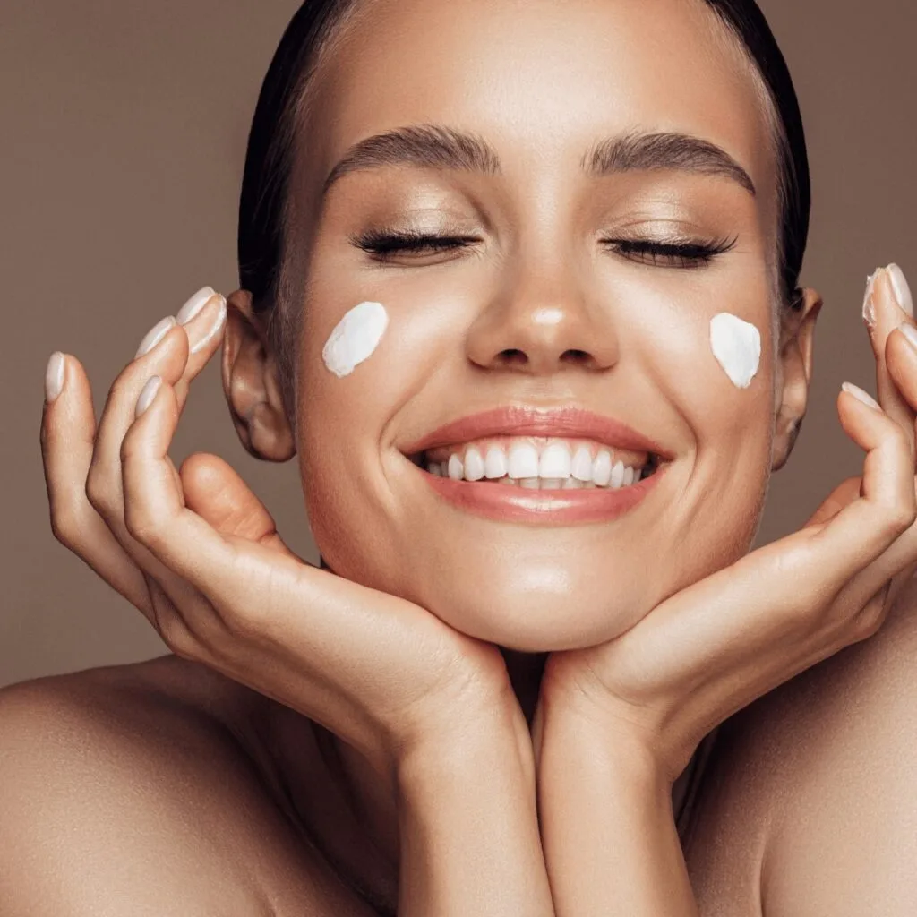 woman smiling with SPF on her face