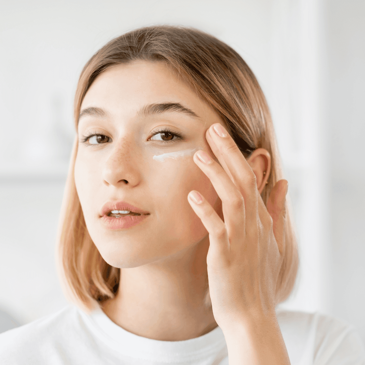 woman applying eye cream