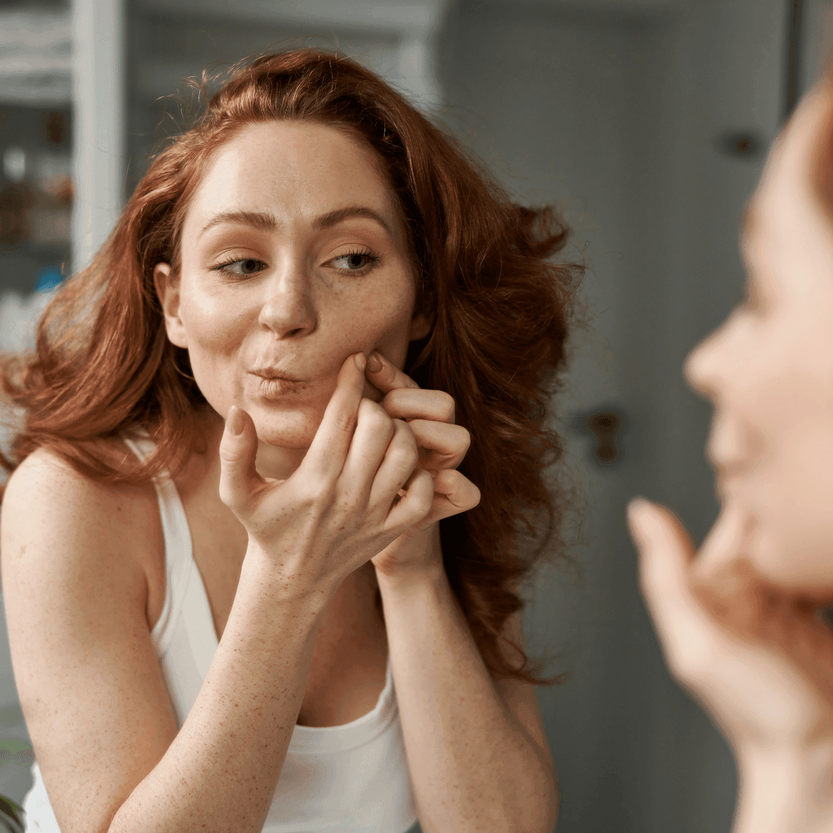 woman noticing skin breakouts
