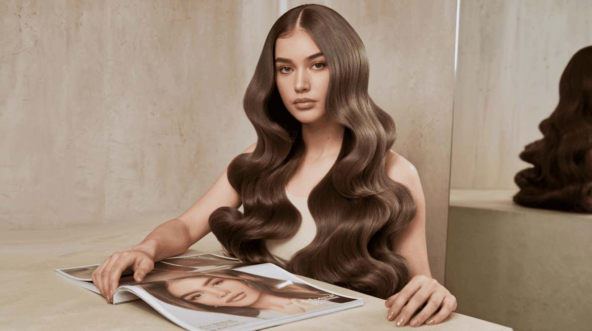 Young woman with long, wavy hair and minimalist aesthetic.