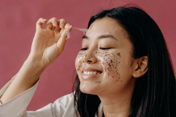 a woman peeling her facemask from her face