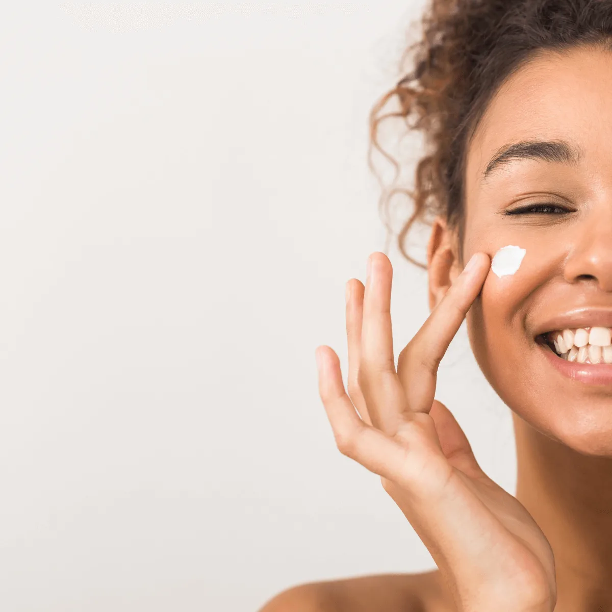 woman applying hydrating face cream