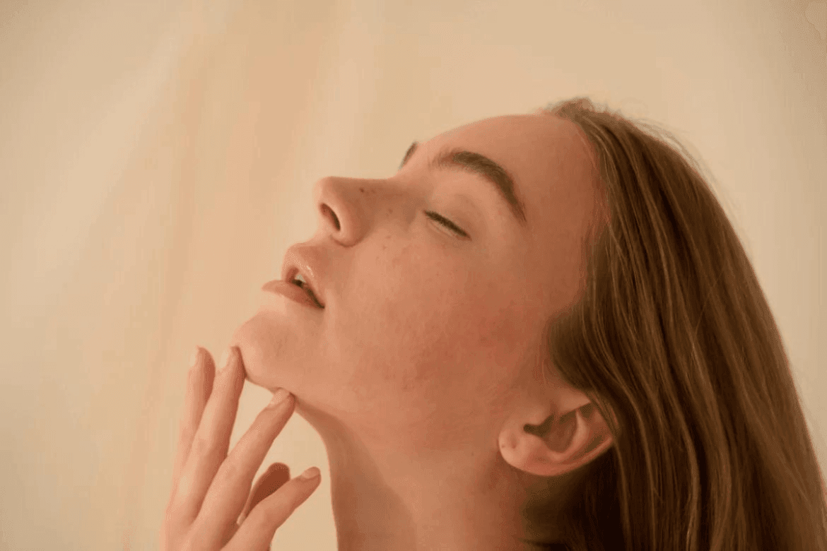 a woman touching her chin