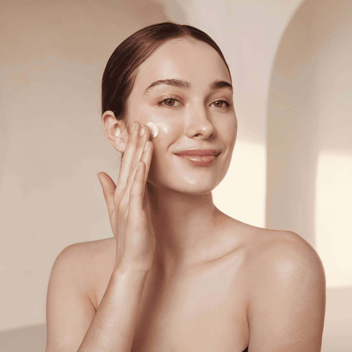 woman applying hydrating face cream