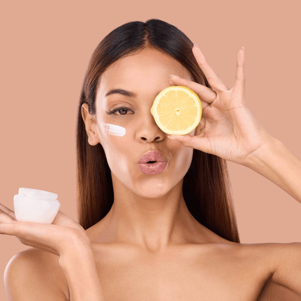 woman holding vitamin C face cream