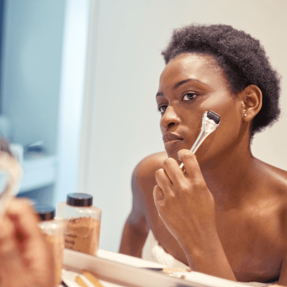 woman doing at-home microneedling