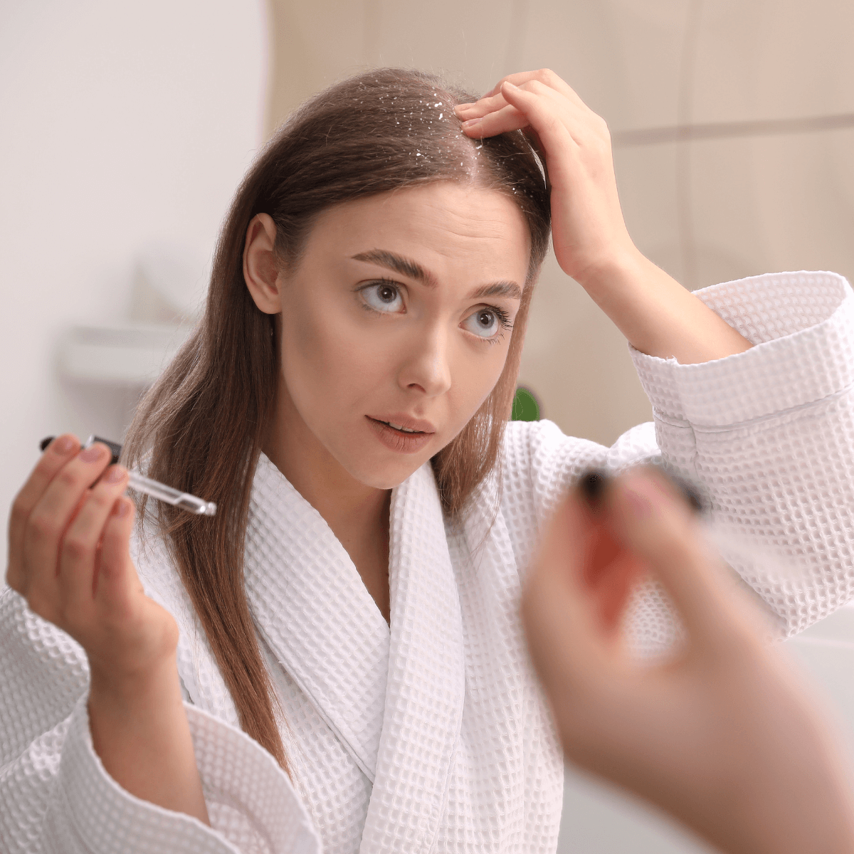 woman applying scalp serum to treat seborrheic dermatitis