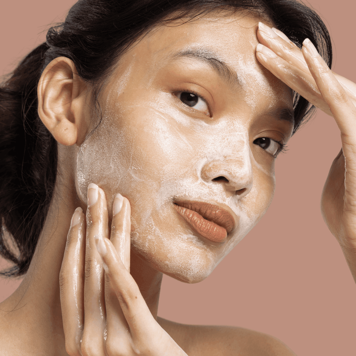woman applying a face mask with active ingredients 