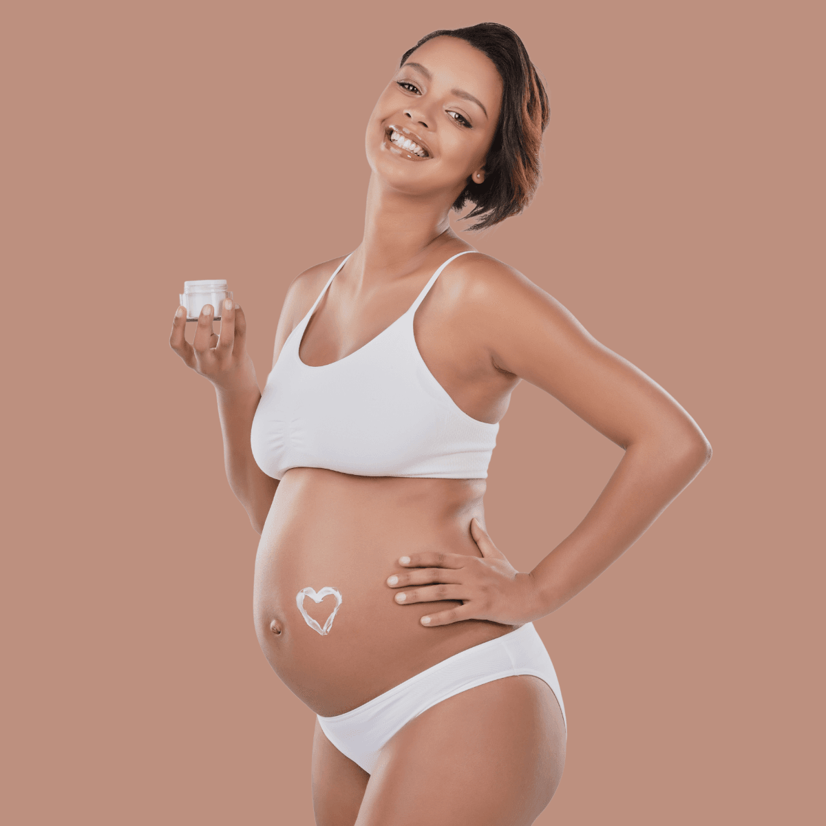 pregnant woman applying moisturizer on her skin